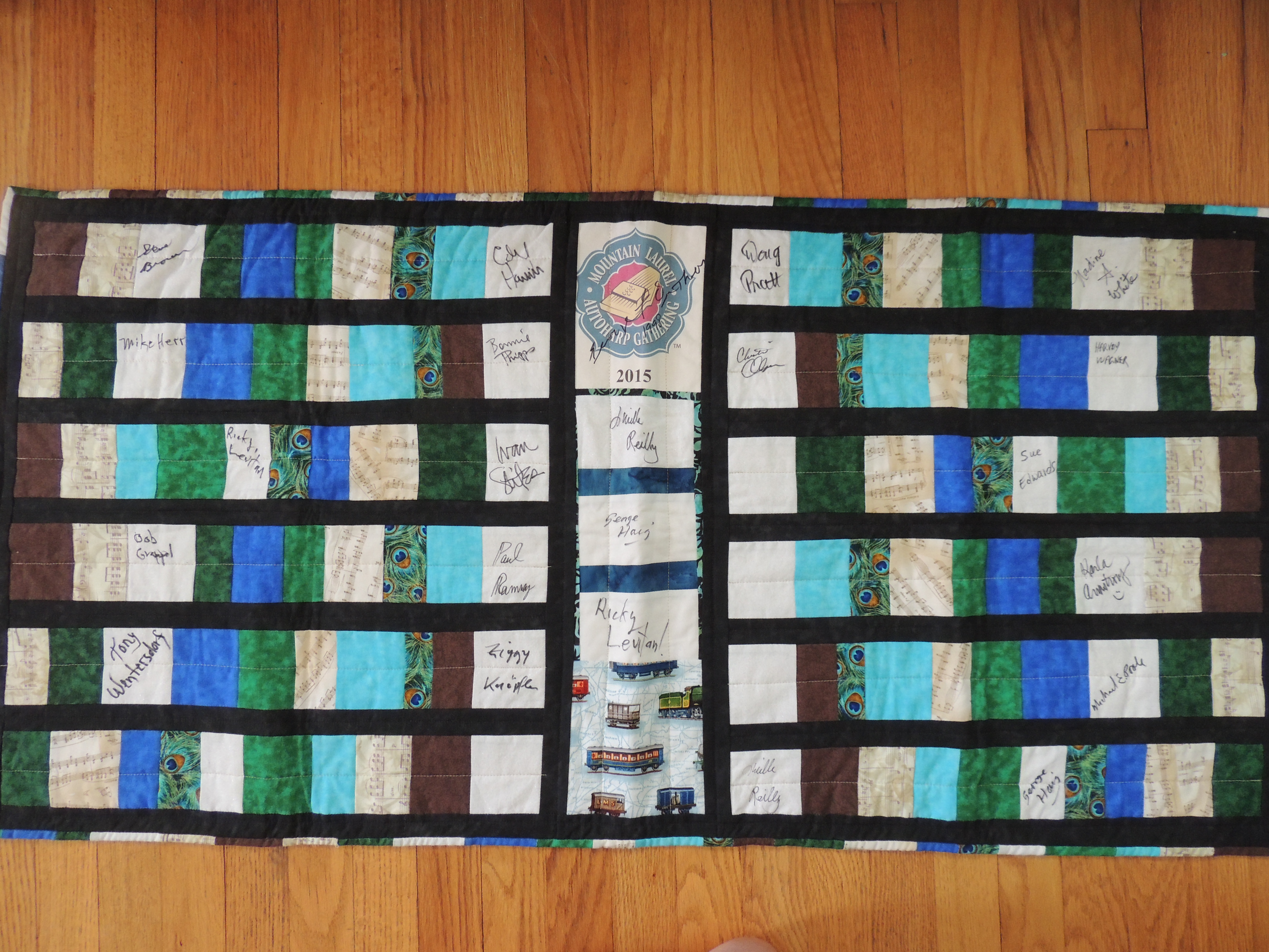 Quilted runner signed by contestants